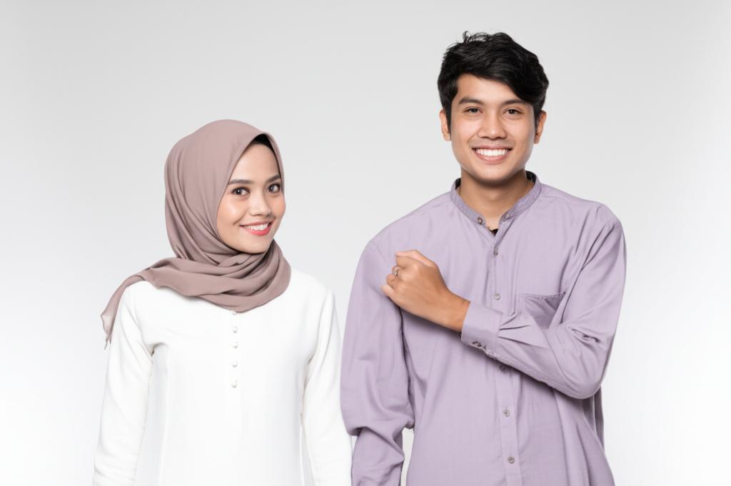 A young Indonesian couple smiling and holding hands, showing renewed intimacy and happiness.