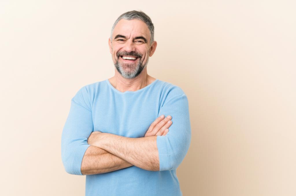 Middle-aged man smiling confidently, looking energetic