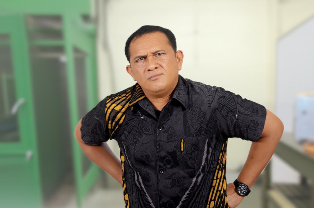 Middle-aged Indonesian man looking tired, holding lower back